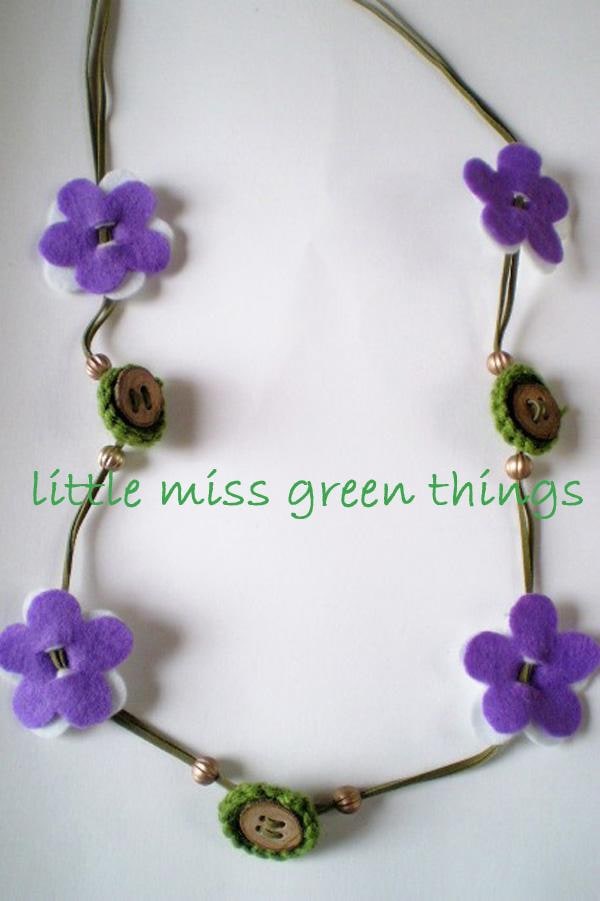 Necklace created by combining leather strings, felt flowers, beads and handmade wooden buttons