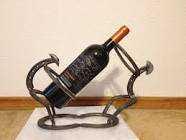 Handcrafted cowboy wine holder. Made from hand selected recycled horseshoes cleaned, polished and crafted to the specific craft.