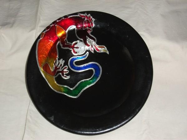 An old ceramic fruit bowl that was a light grey in colour and chipped.
Chips filled with grout, painted black and decorated with Pewter Dragon paint with Glass Stainer.